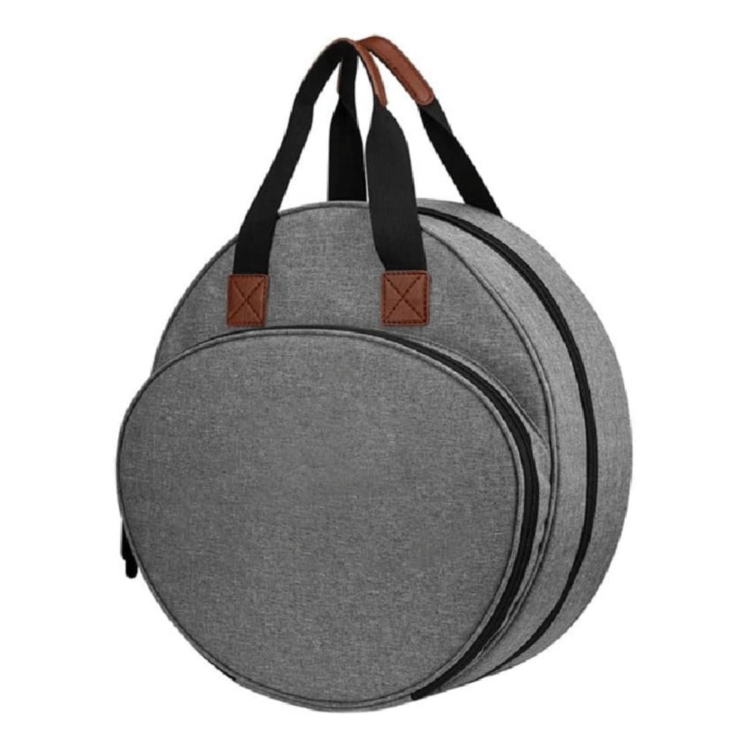 The Embroidery Storage Bag is round and gray, with two black handles and brown leather accents. It has two zippered compartments, making it perfect for organizing your embroidery essentials while combining functionality and style.