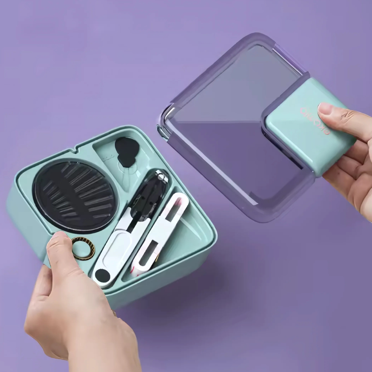 A person opens a compact and portable teal Mini Sewing Kit containing several sewing tools and accessories, against a purple background.