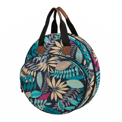 The Embroidery Storage Bag features a vibrant leaf pattern in teal, yellow, pink, and blue on a dark background with black handles, ideal for organizing your embroidery essentials.
