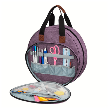 The Embroidery Storage Bag is a round purple backpack with brown handles that unzips to reveal compartments for embroidery essentials like pens, scissors, a ruler, and small notes. Its mesh cover on the lower section displays additional items securely.