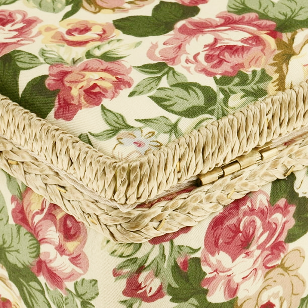The Extra Large Vintage Sewing Basket is expertly crafted, featuring a close-up of its wicker exterior adorned with fabric covered in pink and red roses with lush green leaves.