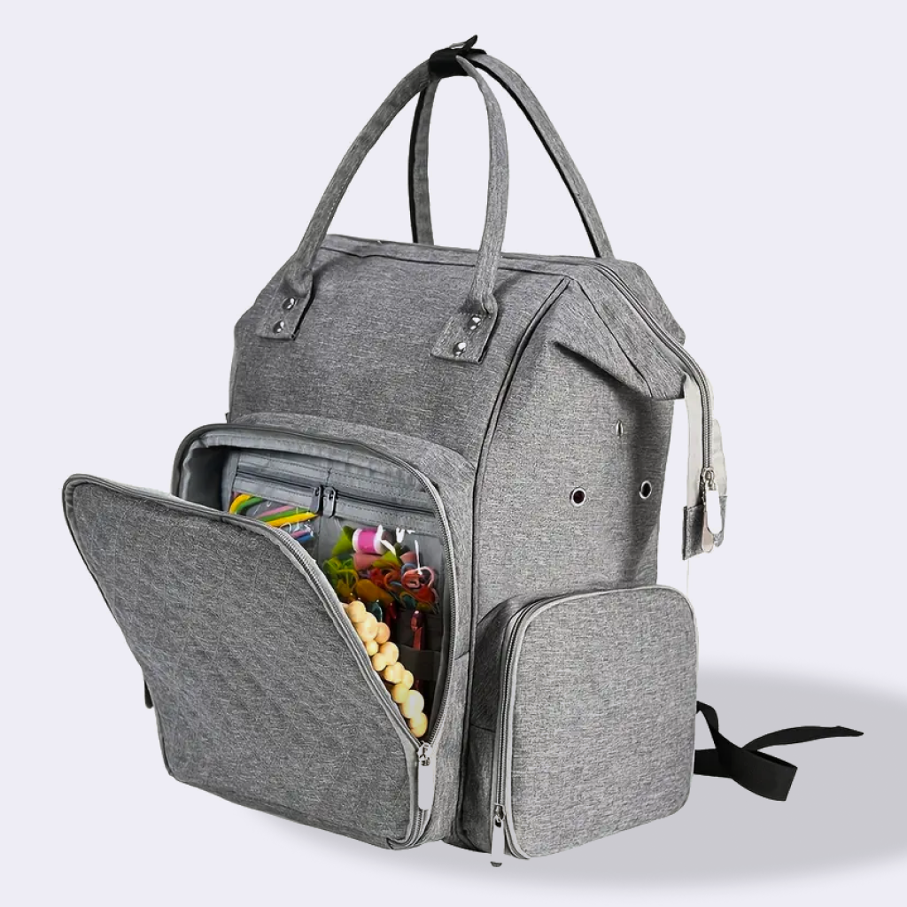The Premium Quilting Organizer Backpack in gray is made from durable 600D Oxford fabric, featuring multiple compartments and a front pocket that opens to reveal neatly organized baby items and accessories.