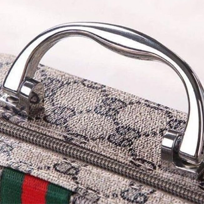 Close-up of the metallic handle on the Sewing Kit In a Stylish Box, featuring a zipper and green and red striped fabric detail—ideal for carrying your compact sewing essentials.
